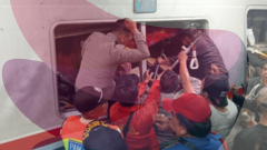 Rescuers race to free survivors trapped inside train after fatal crash